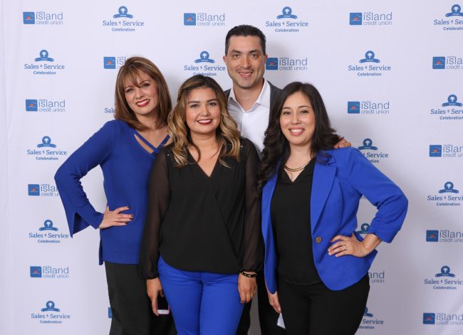 Group in front of Step and Repeat at North Island Credit Union Sales and Service Celebration.