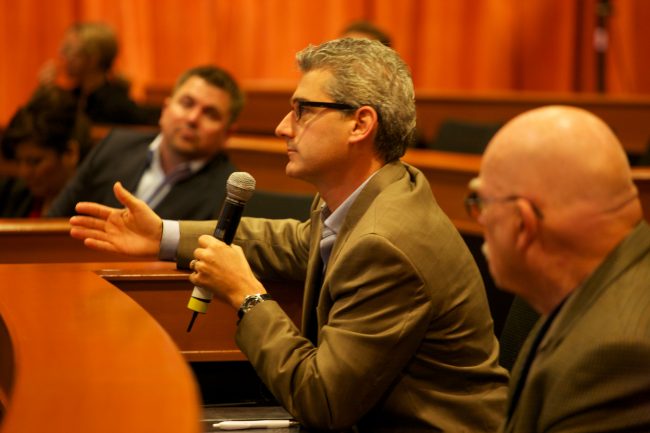 Attendee ask questions during a business meeting