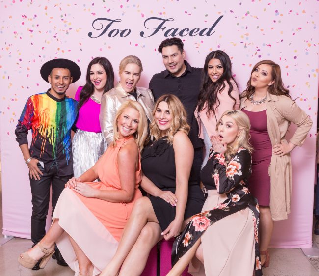 Group in front of step and repeat at Too Faced annual meeting