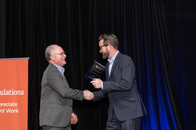 Handshake and award presentation